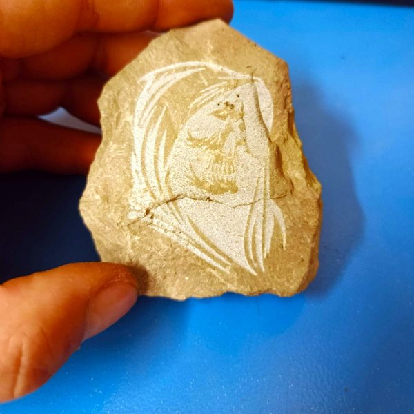 Stone with an engraved portrait drawing